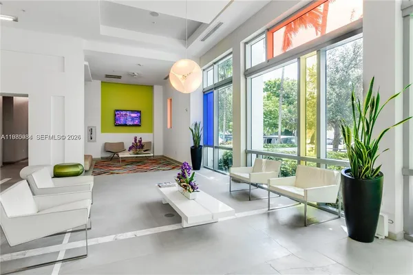 a living room with furniture and a potted plant