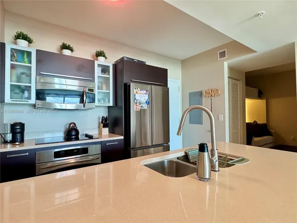 a kitchen with stainless steel appliances granite countertop a sink and cabinets