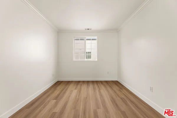 a view of hallway with wooden floor