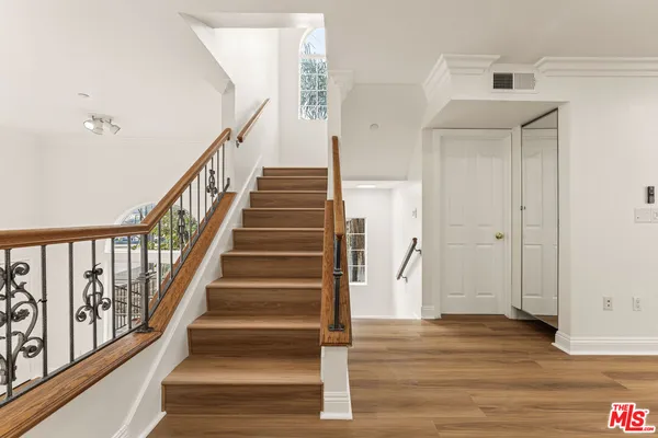 a view of an entryway with wooden floor