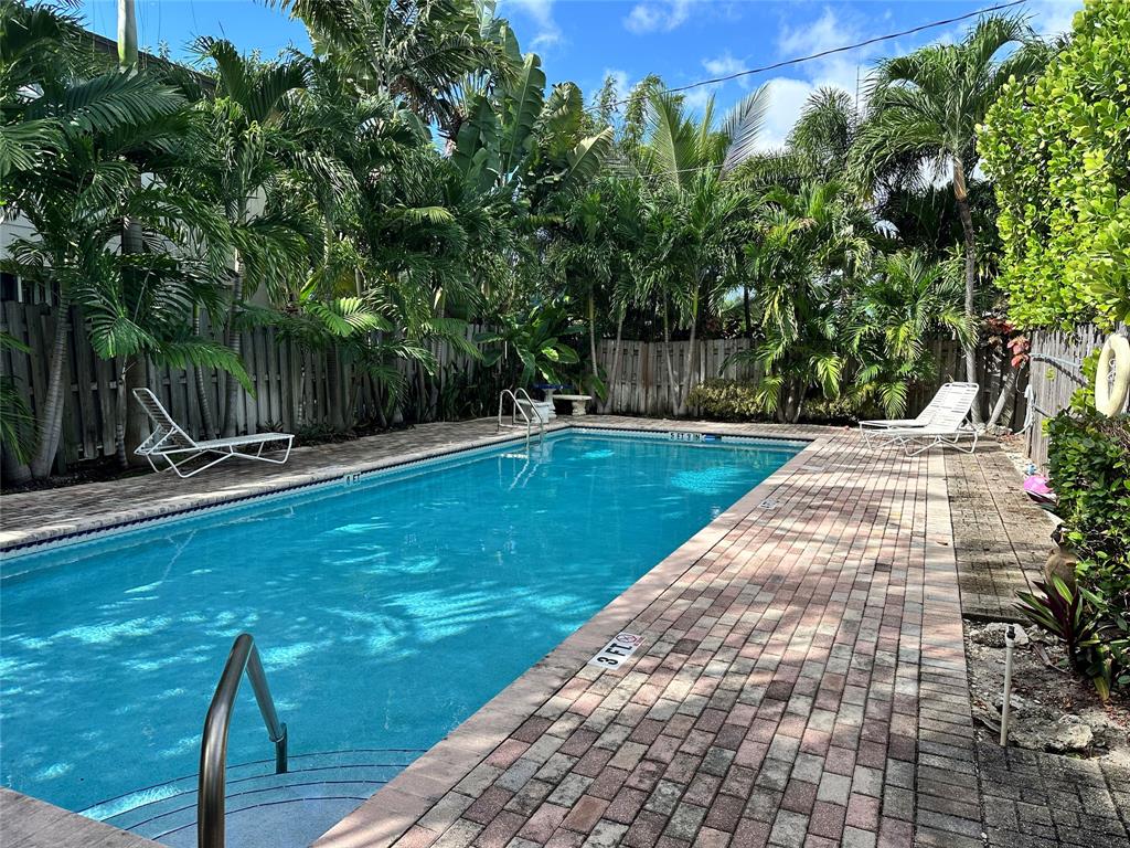 620 Northeast 28th Street, Unit 207 Wilton Manors, FL 33334 - Photo 26 of 30 a view of a swimming pool with a patio