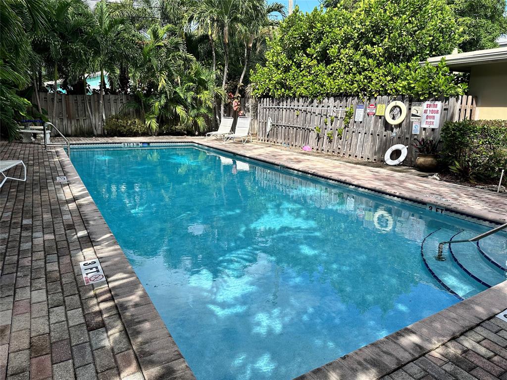 620 Northeast 28th Street, Unit 207 Wilton Manors, FL 33334 - Photo 27 of 30 a view of a swimming pool with a patio