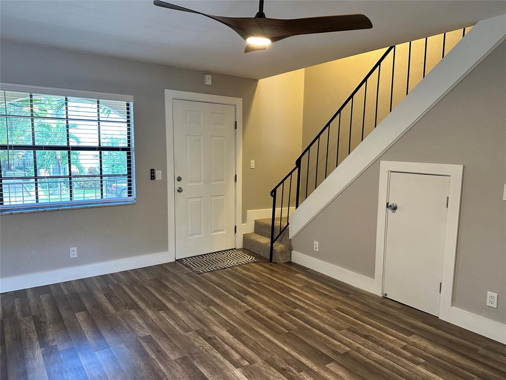 620 Northeast 28th Street, Unit 207 Wilton Manors, FL 33334 - Photo 4 of 30 a view of an entryway with wooden floor and door