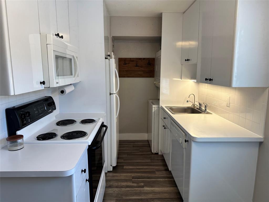 620 Northeast 28th Street, Unit 207 Wilton Manors, FL 33334 - Photo 7 of 30 a kitchen with a sink dishwasher a stove and a refrigerator with wooden floor