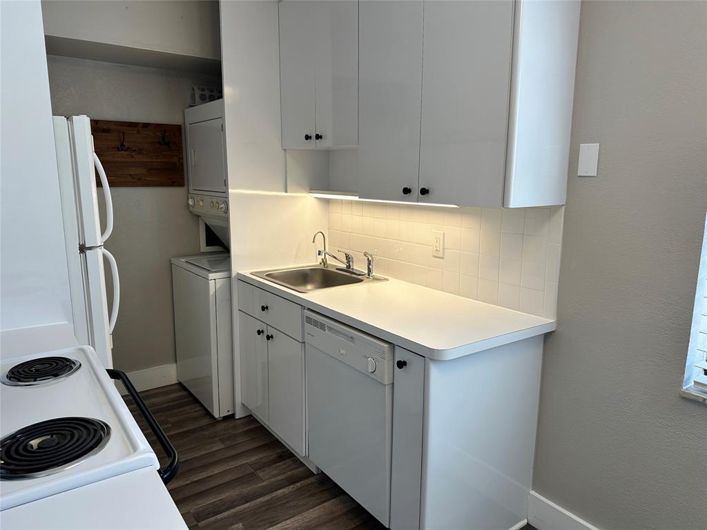 620 Northeast 28th Street, Unit 207 Wilton Manors, FL 33334 - Photo 8 of 30 a utility room with cabinets washer and dryer