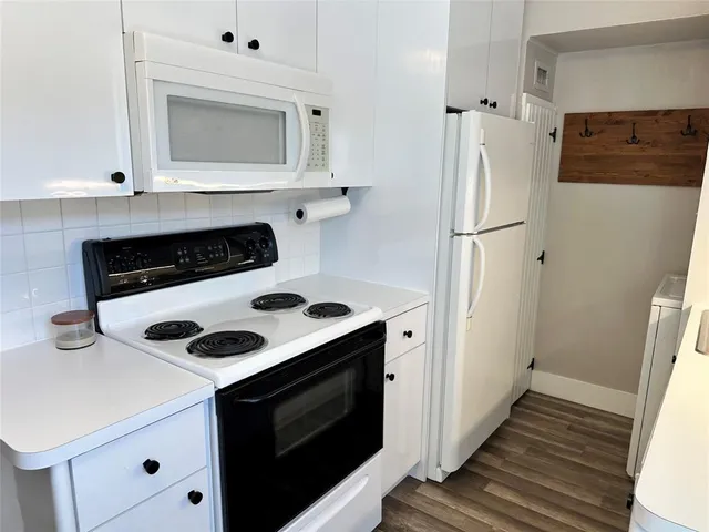 a kitchen with a stove and a microwave