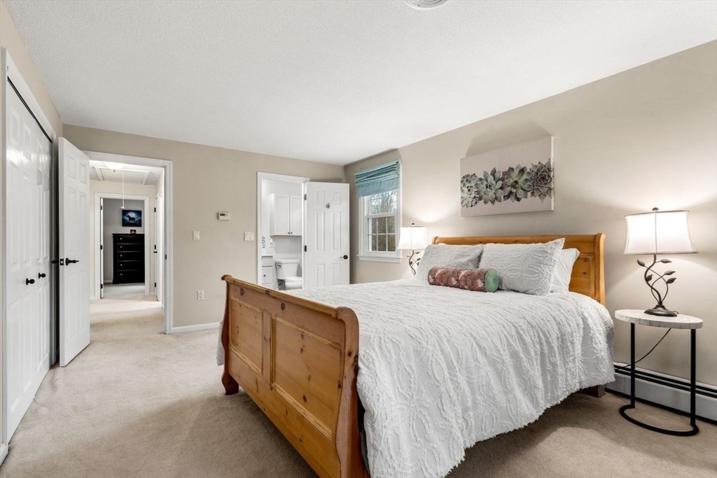 6 Ridge Hill Way Andover, MA 01810 - Photo 16 of 42 a bedroom with a bed and a walk in closet