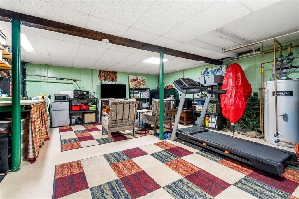 6 Ridge Hill Way Andover, MA 01810 - Photo 28 of 42 a room with furniture flat screen tv and a fireplace