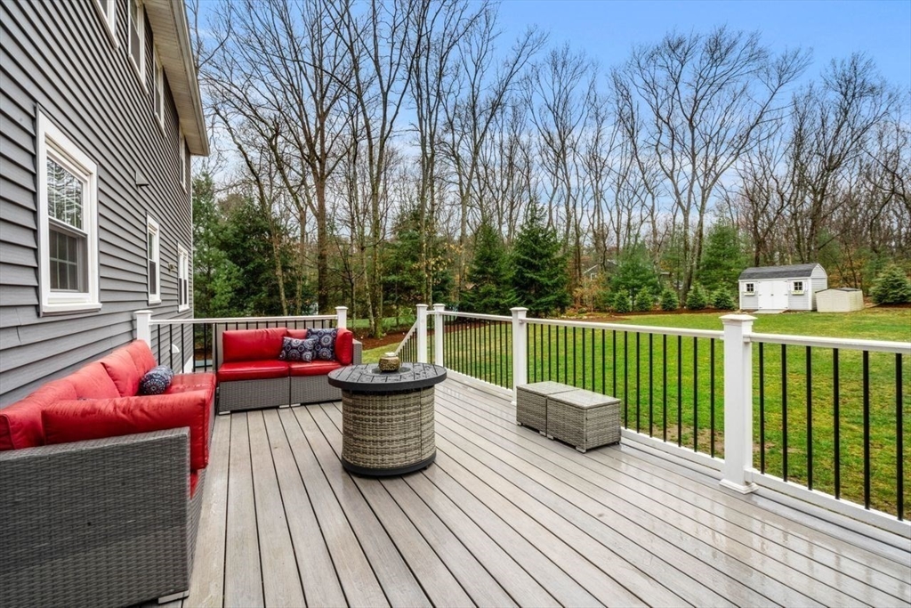 6 Ridge Hill Way Andover, MA 01810 - Photo 29 of 42 a view of a deck with couches table and chairs and wooden floor