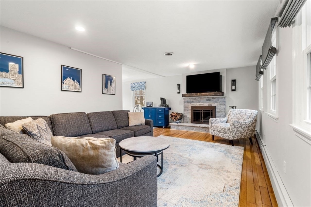 6 Ridge Hill Way Andover, MA 01810 - Photo 3 of 42 a living room with furniture a fireplace and a flat screen tv