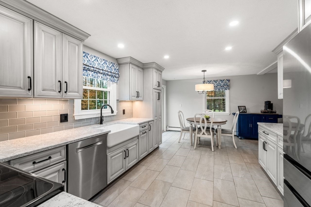 6 Ridge Hill Way Andover, MA 01810 - Photo 8 of 42 a large white kitchen with lots of white cabinets appliances and a window