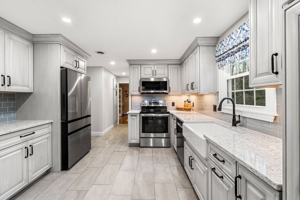 6 Ridge Hill Way Andover, MA 01810 - Photo 9 of 42 a kitchen with granite countertop a refrigerator stove and sink