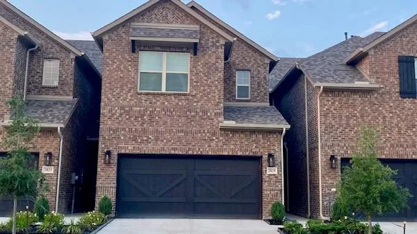 a front view of a house with a brick wall