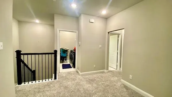an empty room with windows and closet