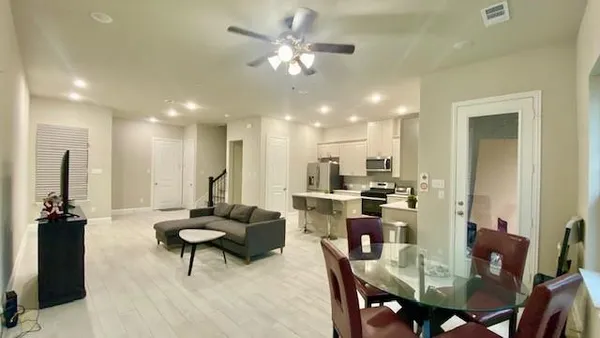 a living room with furniture and kitchen view