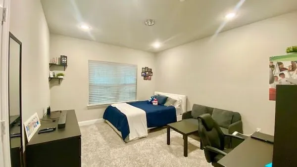 a bedroom with a bed and a chair