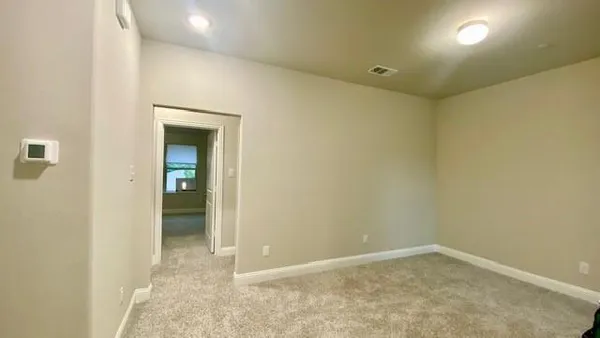 a view of a bathroom from a corridor