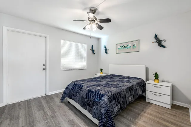 a bedroom with a bed and a ceiling fan