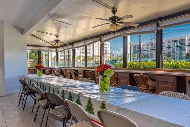 a view of a patio with a table and chairs under an umbrella