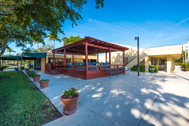 a view of a table and chairs in patio with wooden floor