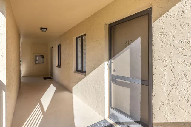 a view of a hallway with closet and wooden floor