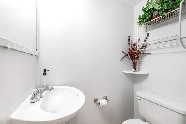 a bathroom with a sink and mirror with toilet