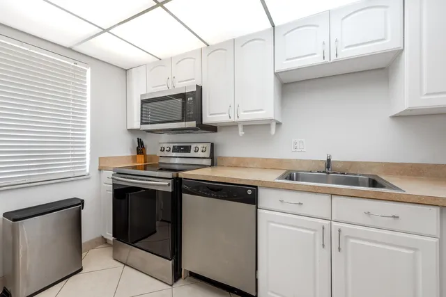 a kitchen with stainless steel appliances granite countertop a sink and a stove