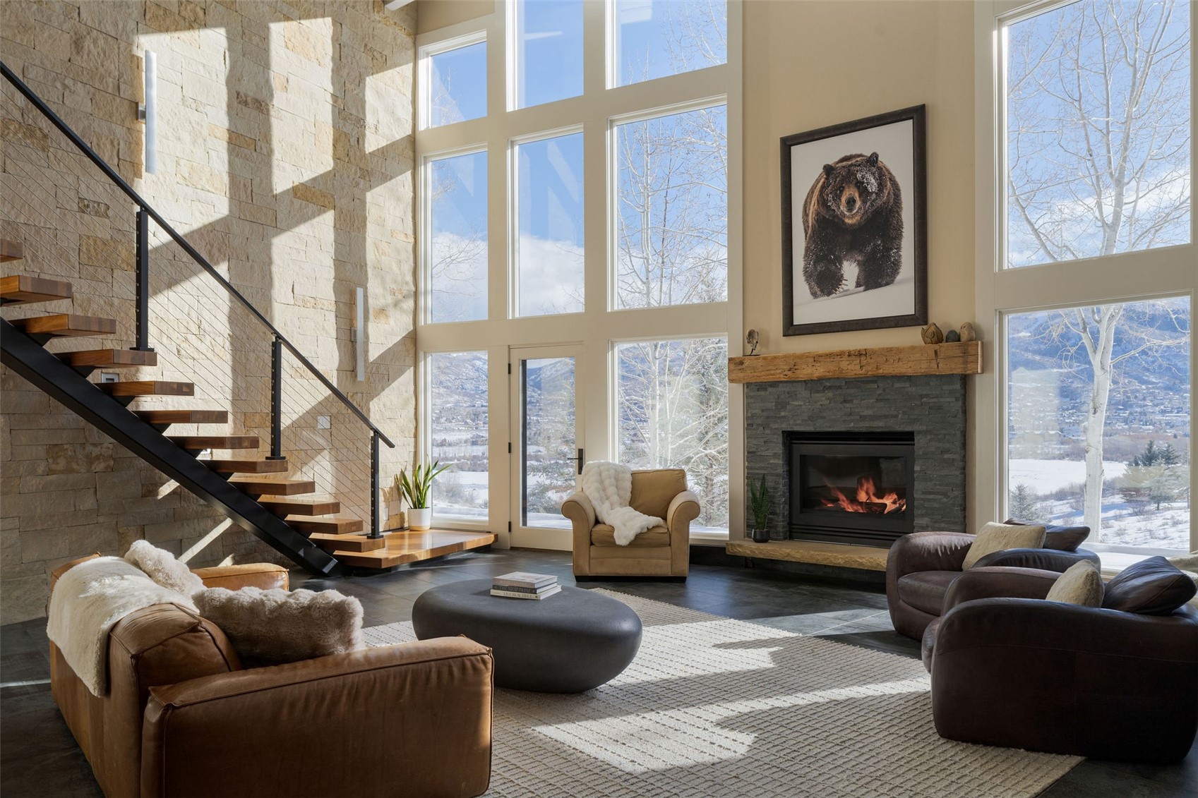 31655 Sugar Ridge Road Steamboat Springs, CO 80487 - Photo 1 of 49 a living room with furniture a fireplace and a large window