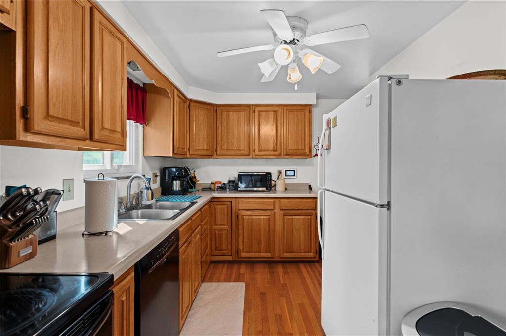 800 Burchfield Road Allison Park, PA 15101 - Photo 9 of 30 a kitchen with stainless steel appliances granite countertop a refrigerator a sink dishwasher a stove with wooden cabinets and floor