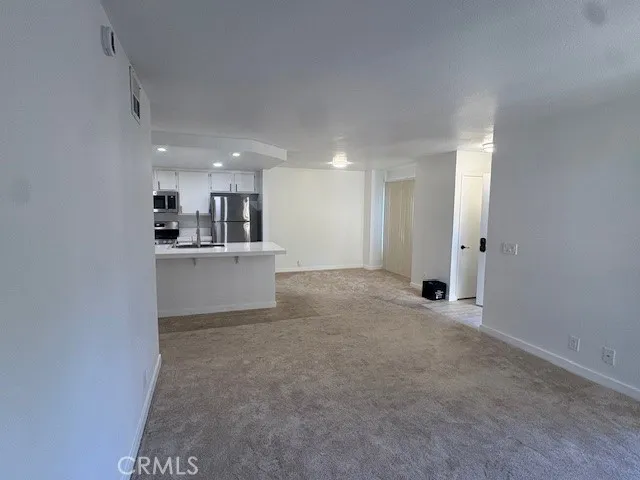 a view of a kitchen with a sink and cabinets