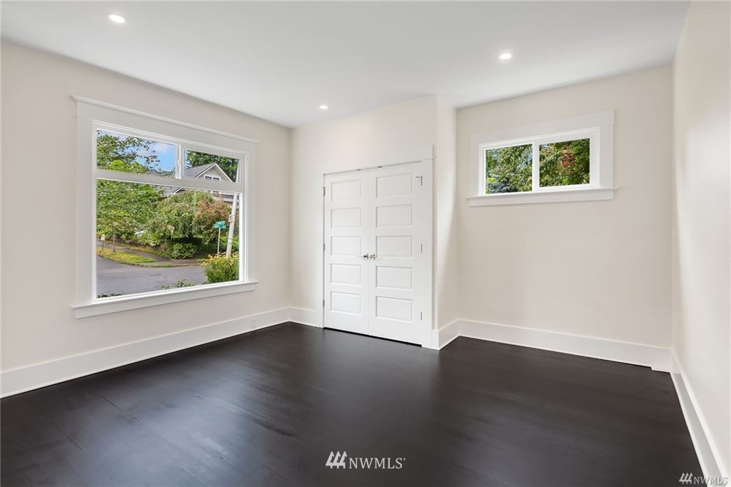 206 30th Avenue Seattle, WA 98122 - Photo 13 of 21 a view of an empty room with wooden floor and a window