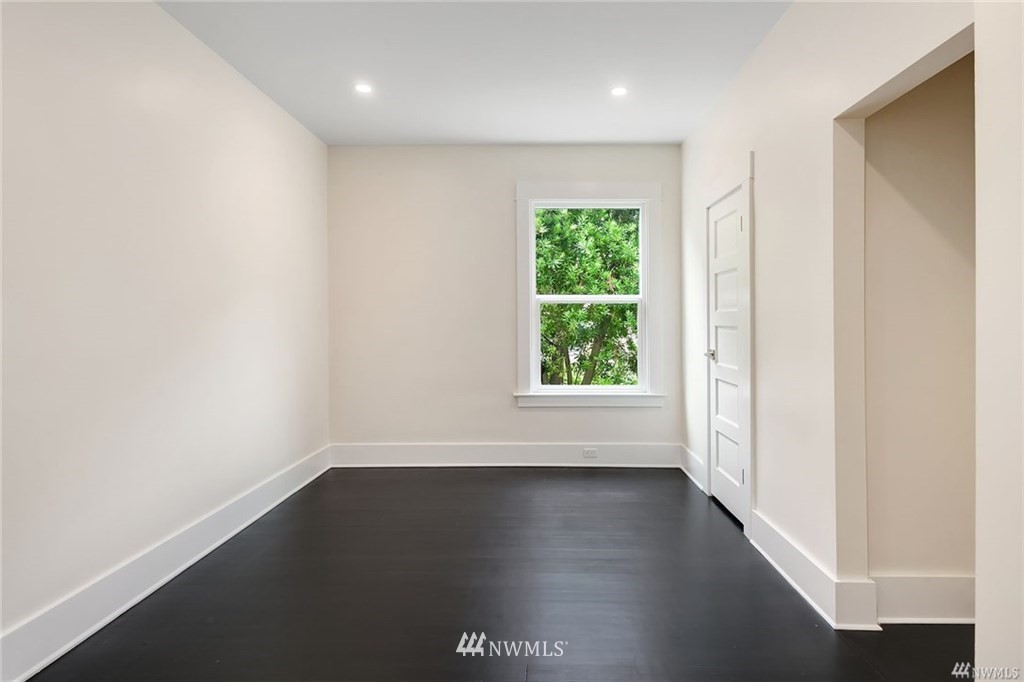 206 30th Avenue Seattle, WA 98122 - Photo 14 of 21 an empty room with wooden floor and windows