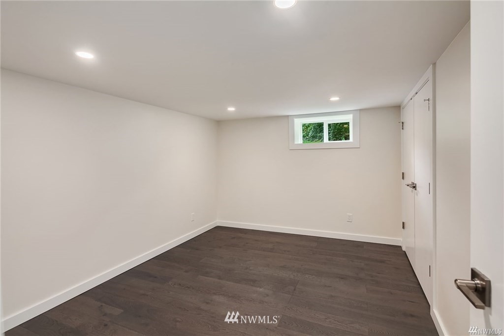 206 30th Avenue Seattle, WA 98122 - Photo 17 of 21 an empty room with wooden floor and windows
