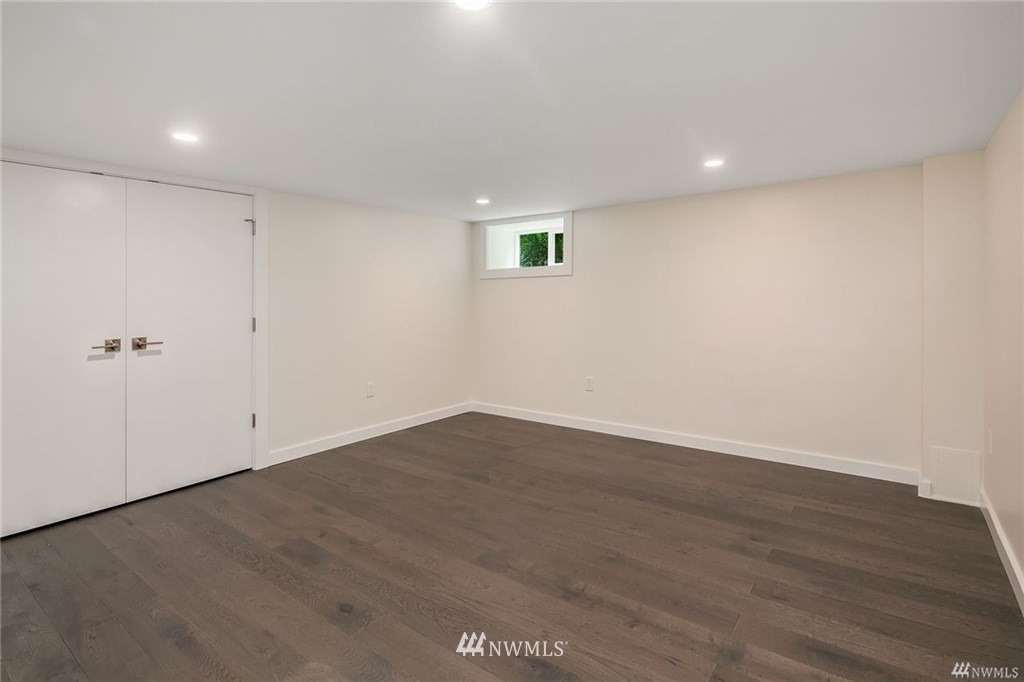206 30th Avenue Seattle, WA 98122 - Photo 20 of 21 an empty room with wooden floor and white wall