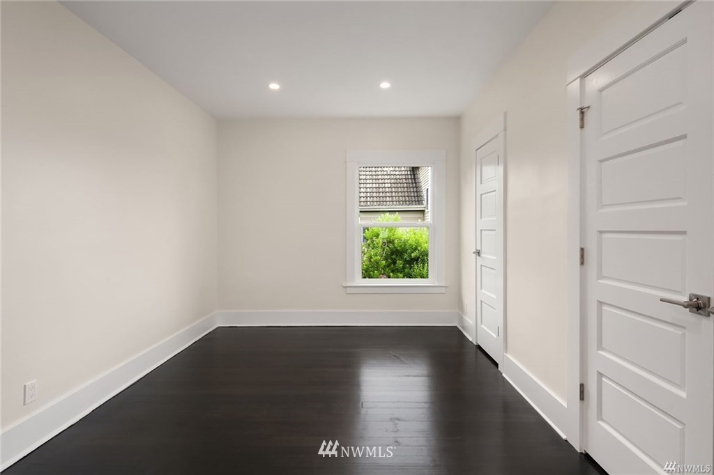 206 30th Avenue Seattle, WA 98122 - Photo 3 of 21 a view of an empty room with wooden floor and a window