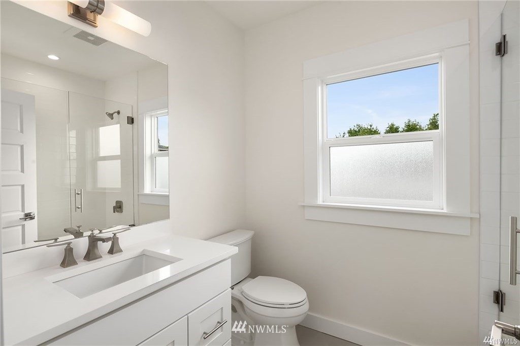206 30th Avenue Seattle, WA 98122 - Photo 5 of 21 a bathroom with a granite countertop sink toilet and mirror