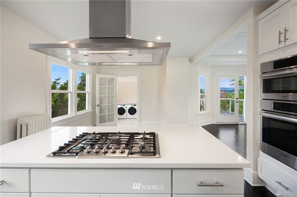 206 30th Avenue Seattle, WA 98122 - Photo 7 of 21 a kitchen with stainless steel appliances granite countertop a stove and a white cabinets