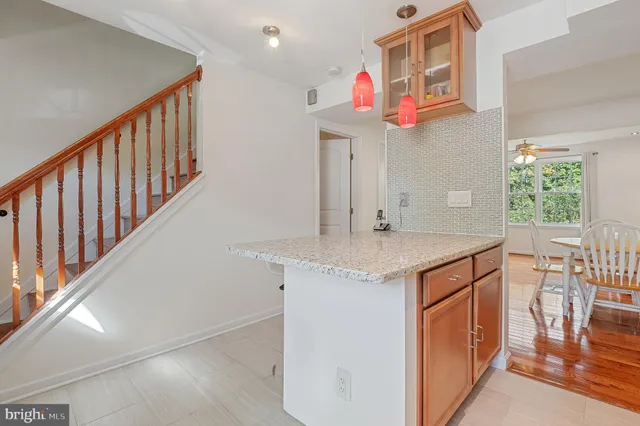 a kitchen with stainless steel appliances granite countertop a sink and a refrigerator