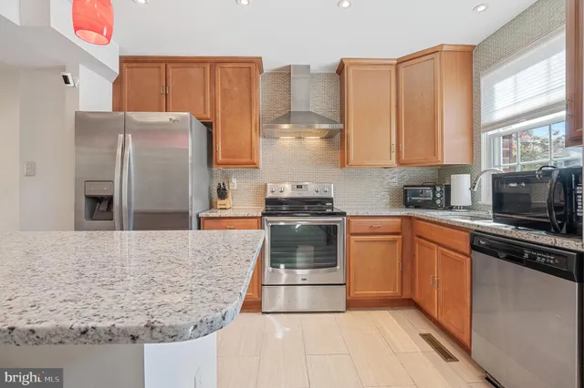 a en suite bathroom with a granite countertop tub and a sink