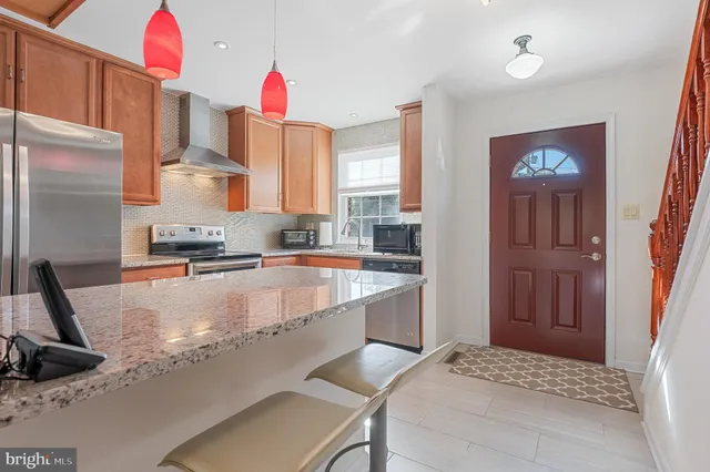 a view of a hallway with a livingroom and a dinning room with windows