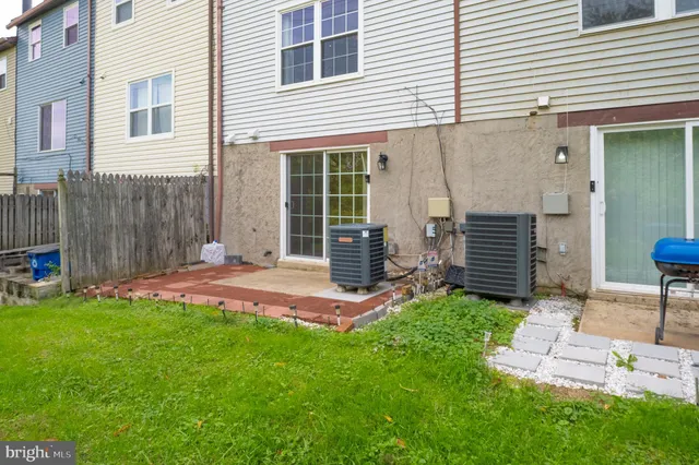 a front view of multiple houses with yard