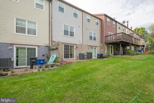 a view of a house with a backyard and sitting area