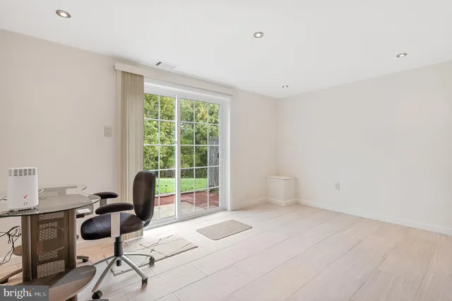 a spacious bathroom with a toilet a sink and a mirror