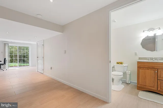 a bathroom with a toilet a sink and a mirror