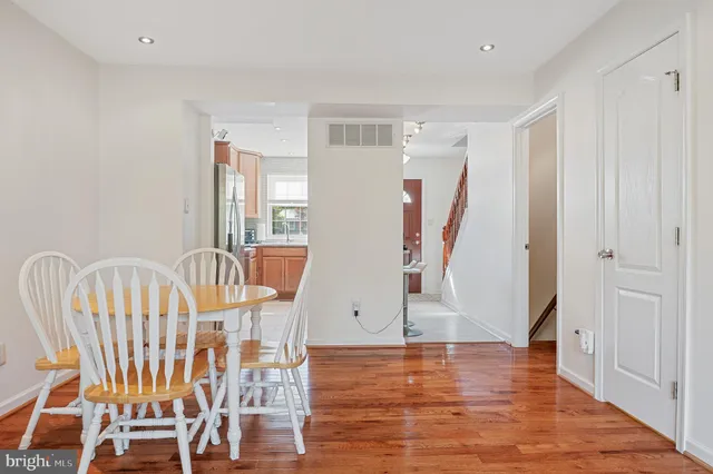 a view of a hallway with wooden floor and windows