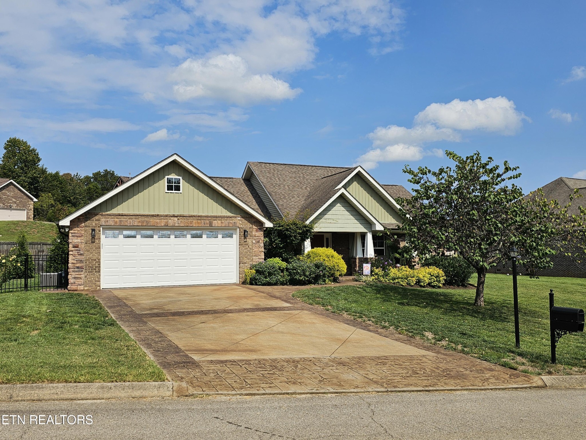 a view of a house with a yard and large trees