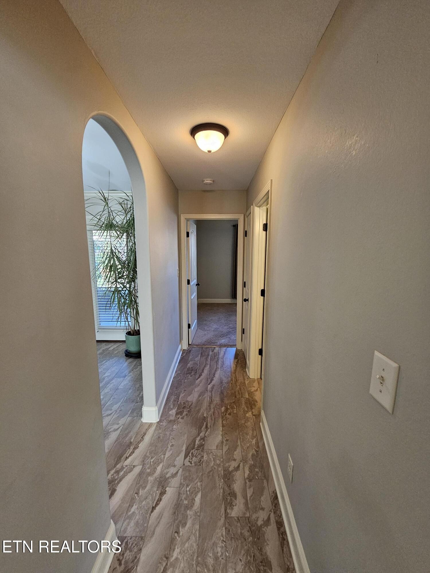 5920 Whisper Ridge Lane Corryton, TN 37721 - Photo 25 of 49 a view of hallway with wooden floor and a large window