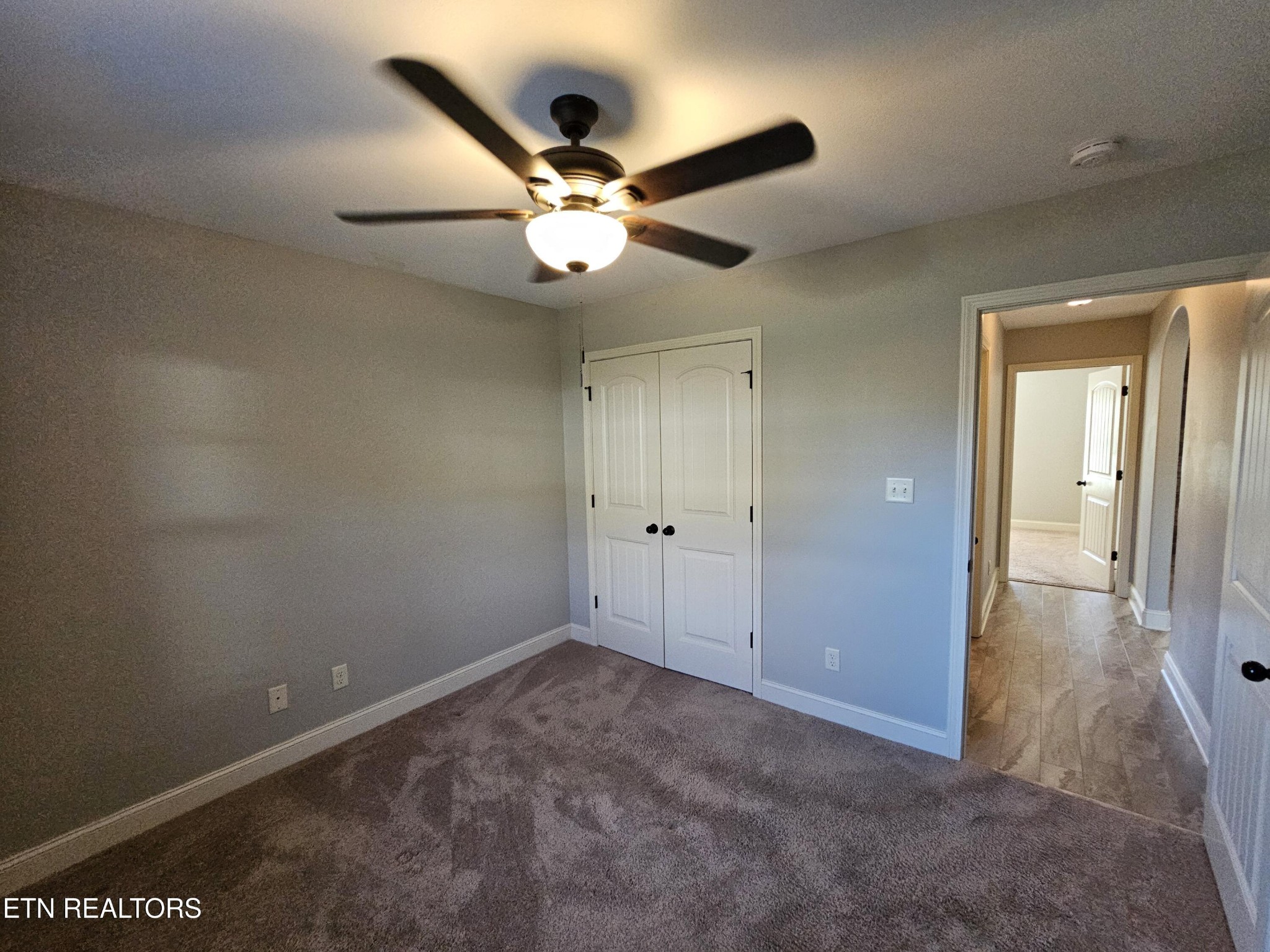 5920 Whisper Ridge Lane Corryton, TN 37721 - Photo 27 of 49 an empty room with closet and a chandelier fan
