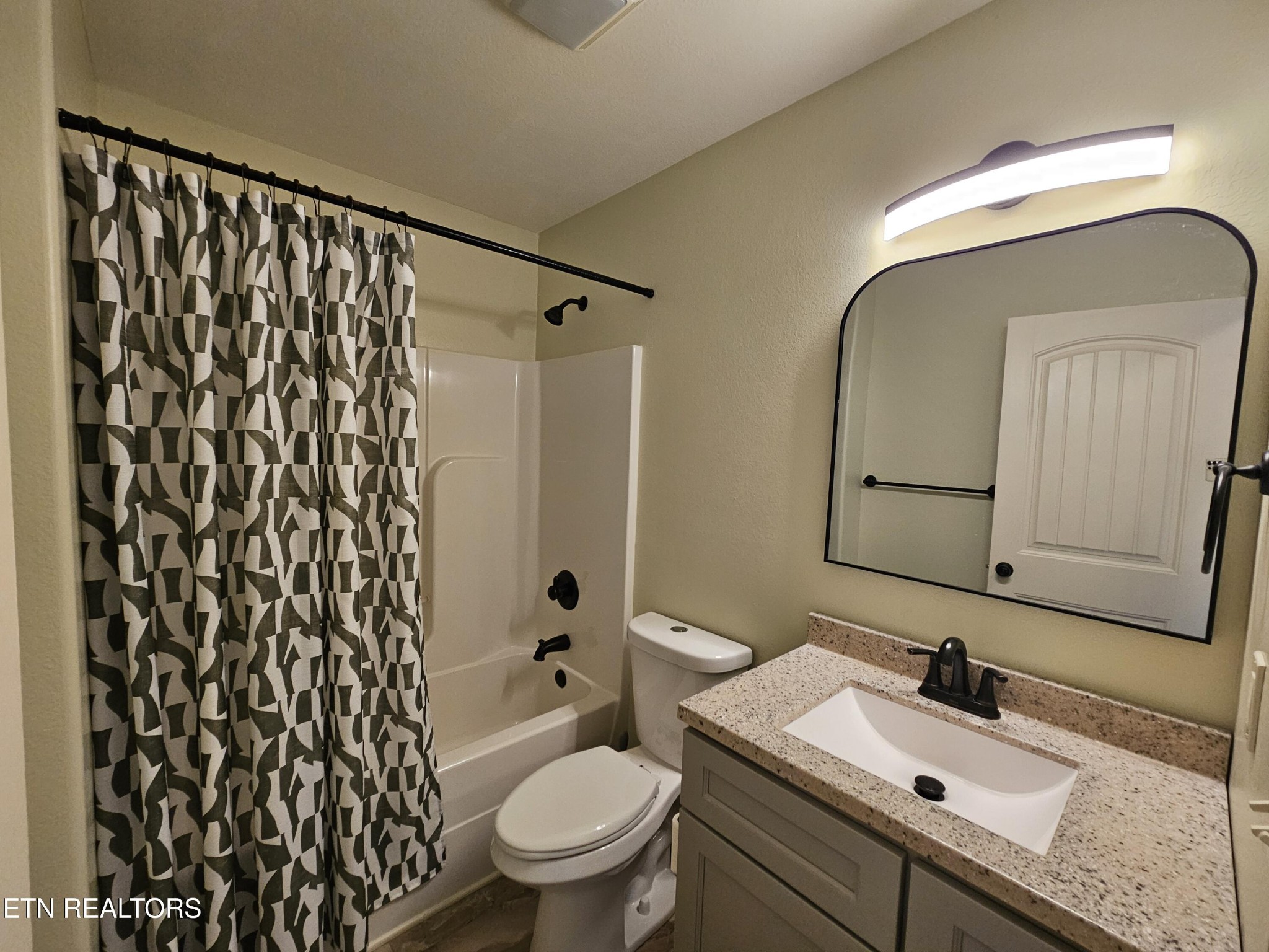 5920 Whisper Ridge Lane Corryton, TN 37721 - Photo 28 of 49 a bathroom with a granite countertop sink mirror vanity and toilet