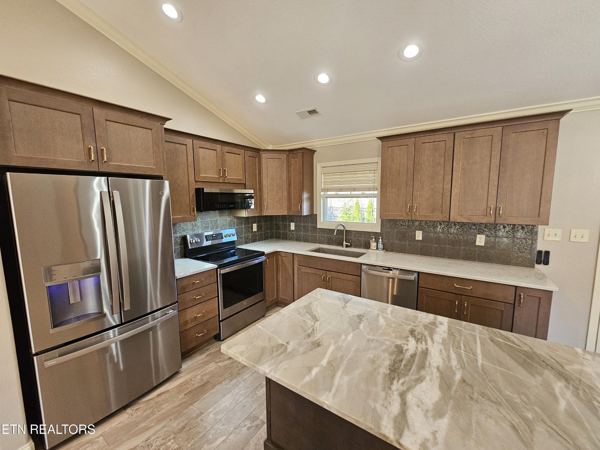 5920 Whisper Ridge Lane Corryton, TN 37721 - Photo 3 of 49 a kitchen with granite countertop a refrigerator stove and sink